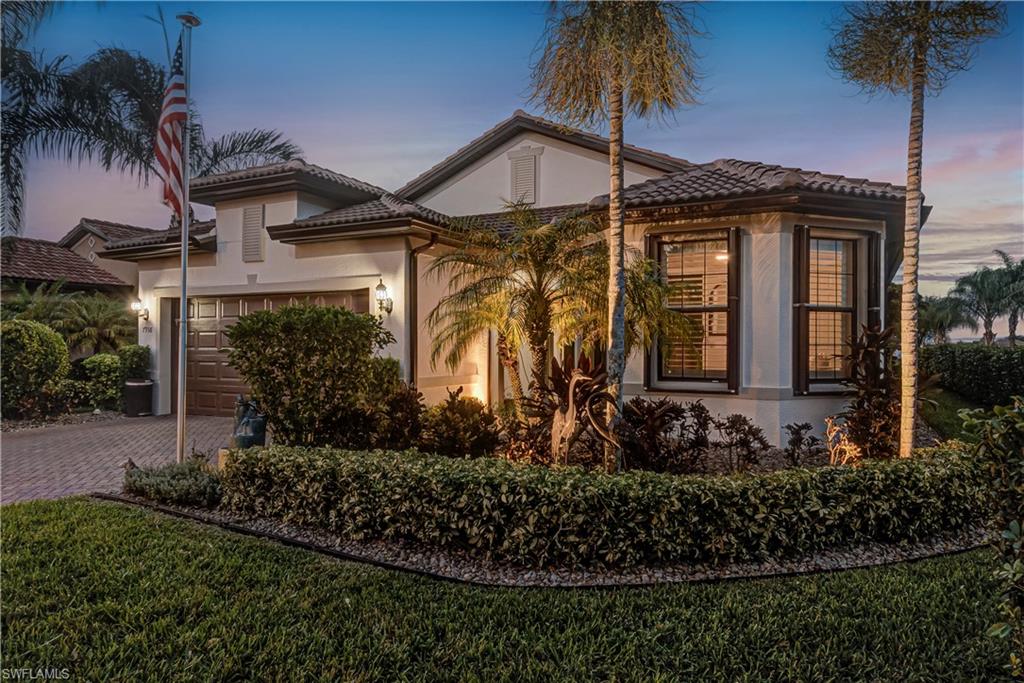 7938 Guadiana Way Ave Maria, FL 34142 - Photo 33 of 37 a front view of a house with garden