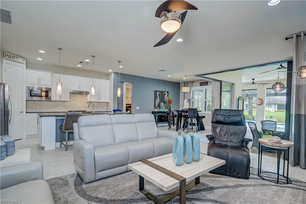 7938 Guadiana Way Ave Maria, FL 34142 - Photo 8 of 37 a living room with furniture kitchen view and a chandelier