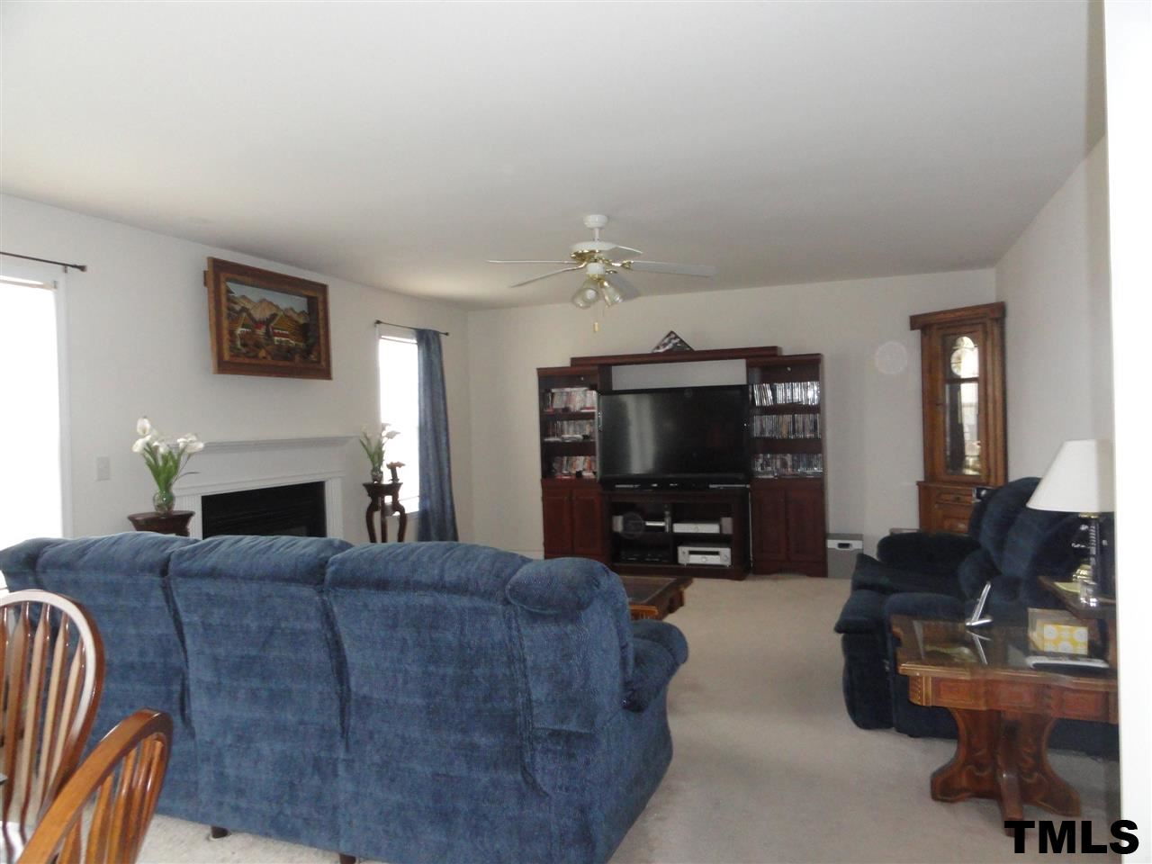 904 Morning Still Court Rolesville, NC 27571 - Photo 2 of 25 a living room with furniture a fireplace and a flat screen tv