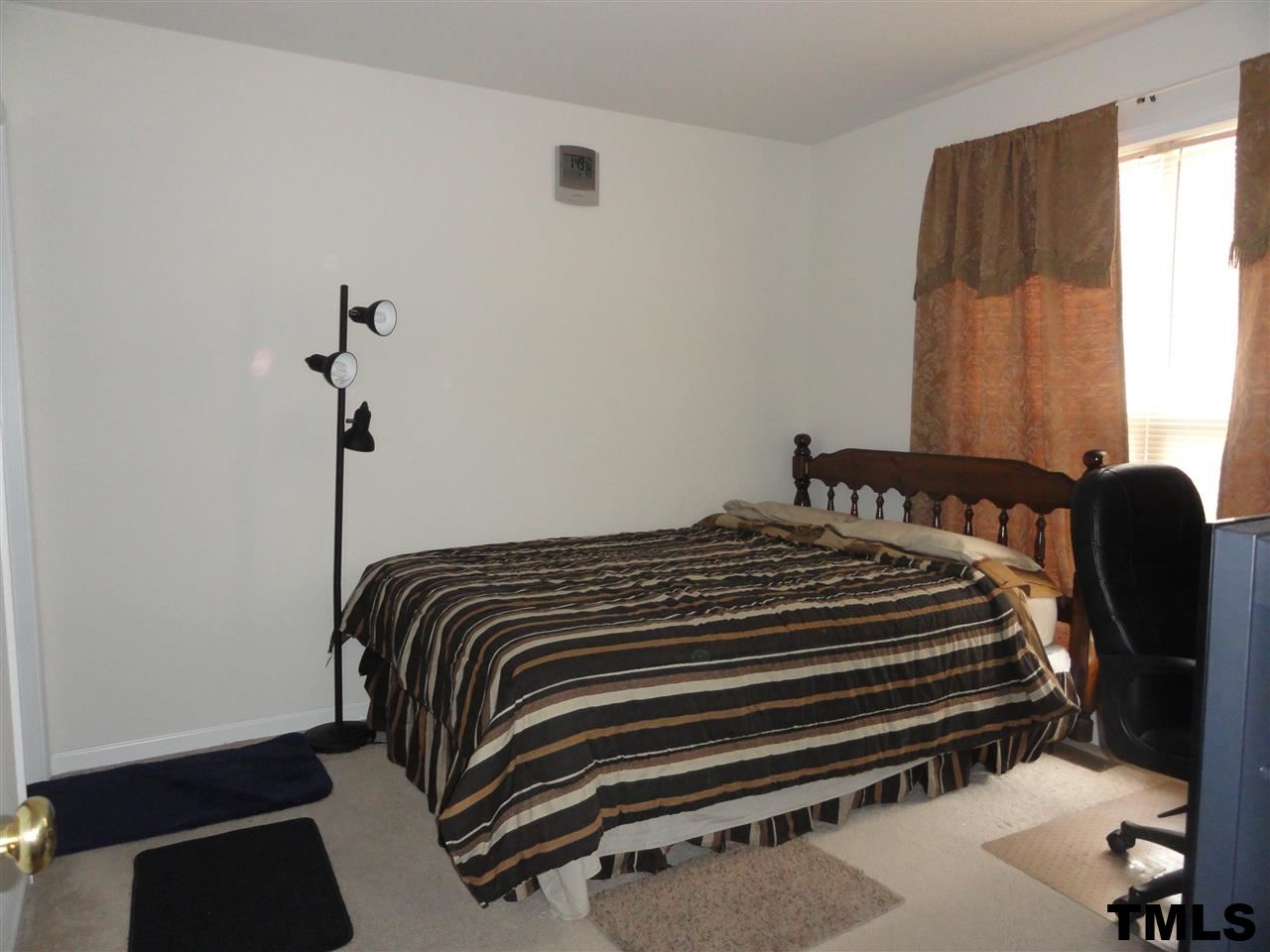 904 Morning Still Court Rolesville, NC 27571 - Photo 12 of 25 a bedroom with a bed and a window