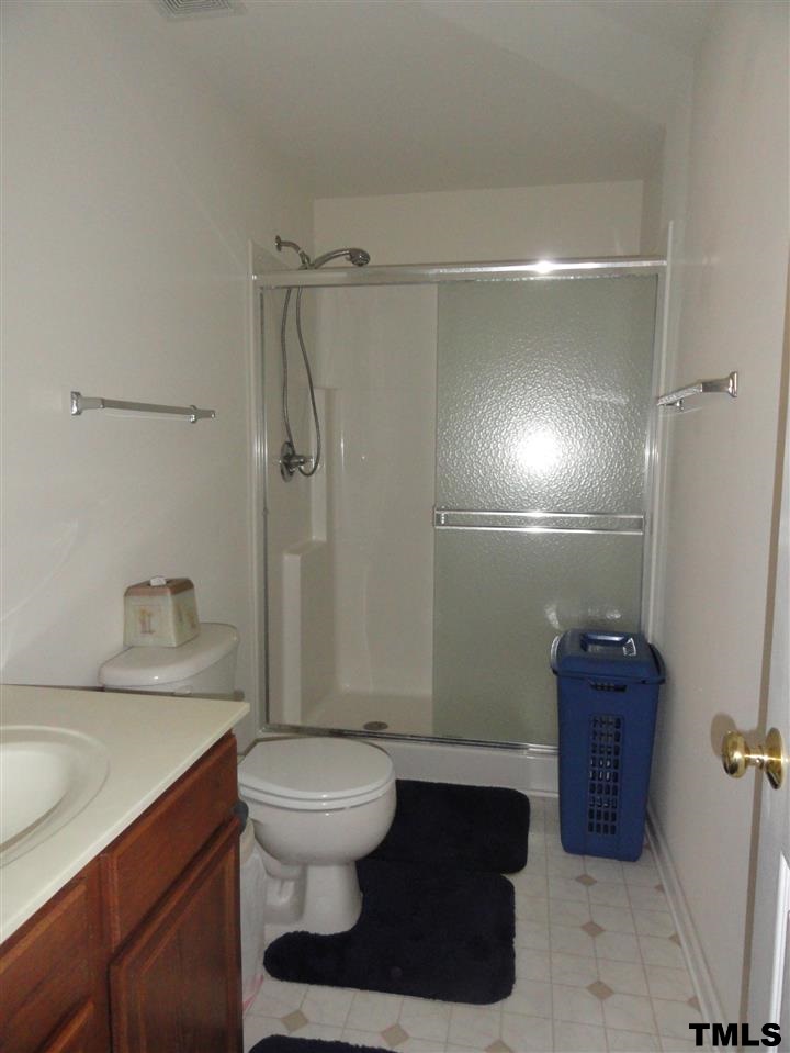 904 Morning Still Court Rolesville, NC 27571 - Photo 13 of 25 a bathroom with a sink a toilet and shower