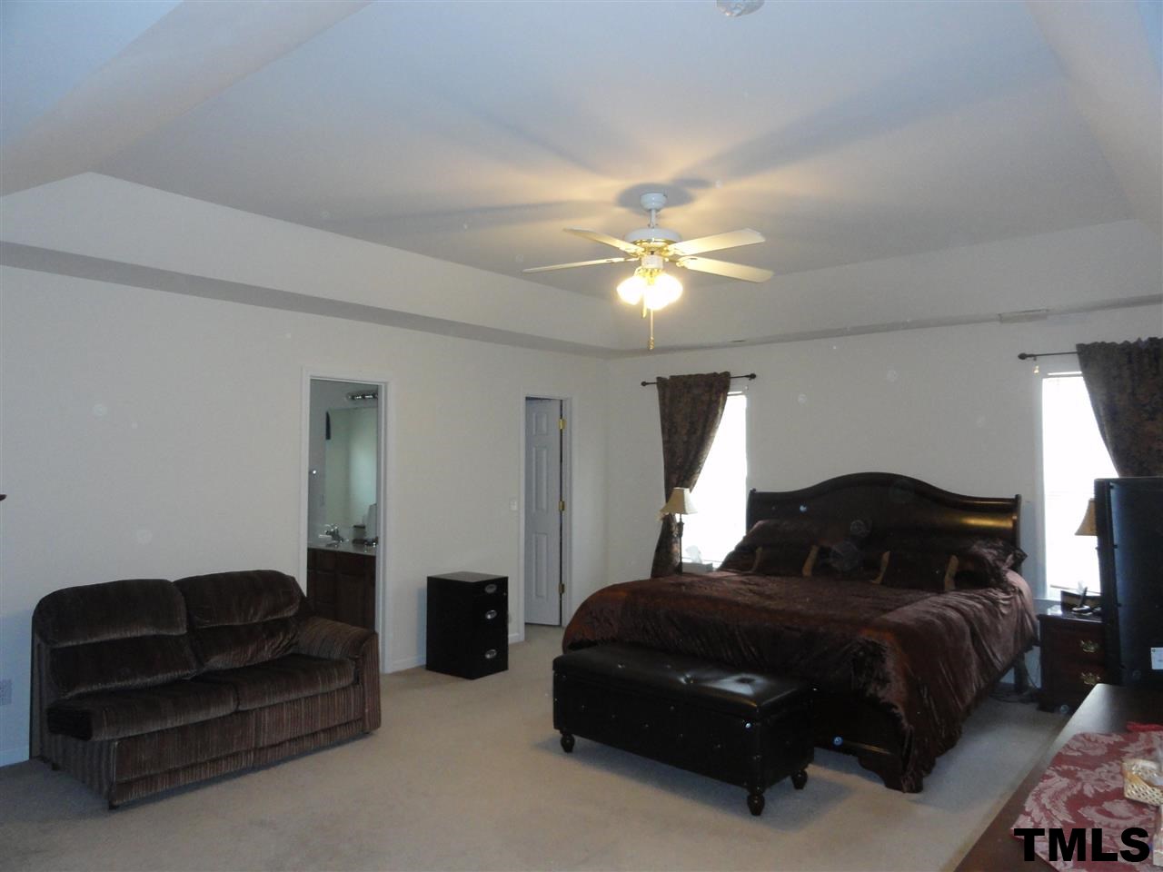 904 Morning Still Court Rolesville, NC 27571 - Photo 15 of 25 a bedroom with a bed lamp and a chandelier