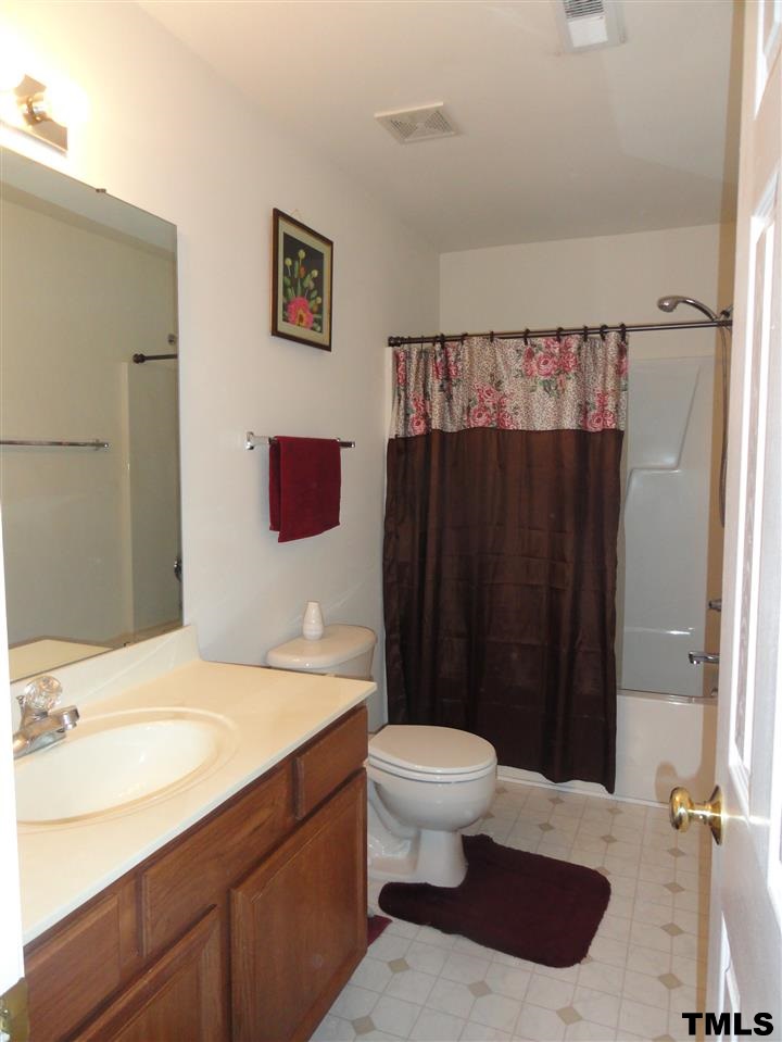 904 Morning Still Court Rolesville, NC 27571 - Photo 20 of 25 a bathroom with a sink and a mirror