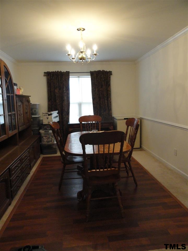 904 Morning Still Court Rolesville, NC 27571 - Photo 8 of 25 a view of a dining room with furniture window and wooden floor