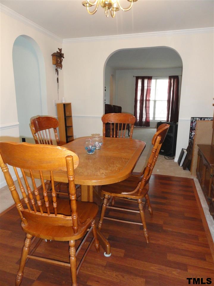904 Morning Still Court Rolesville, NC 27571 - Photo 9 of 25 a view of a dining room with furniture and wooden floor