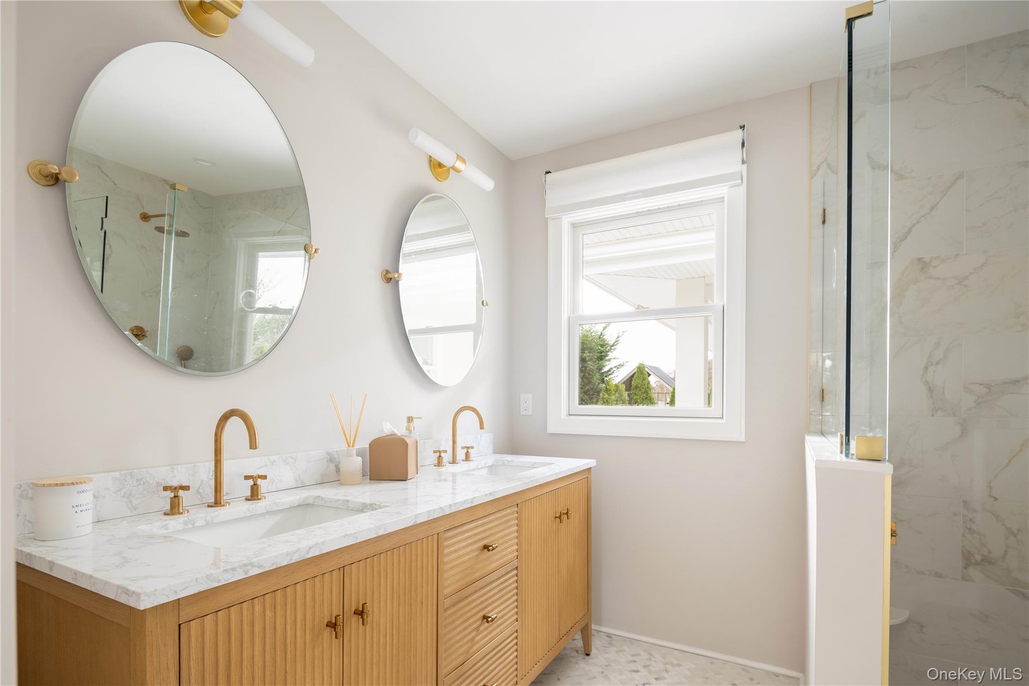1995 Ruth Road Mattituck, NY 11952 - Photo 12 of 32 a bathroom with a double vanity sink and a mirror