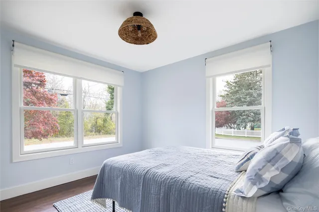 a bedroom with a large bed and a large window