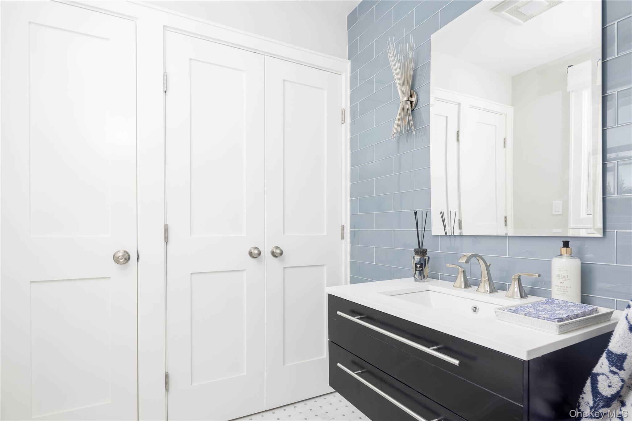1995 Ruth Road Mattituck, NY 11952 - Photo 16 of 32 a bathroom with a sink a mirror and a shower