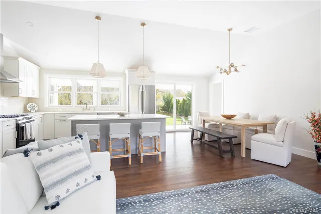 a living room with lots of furniture and a chandelier