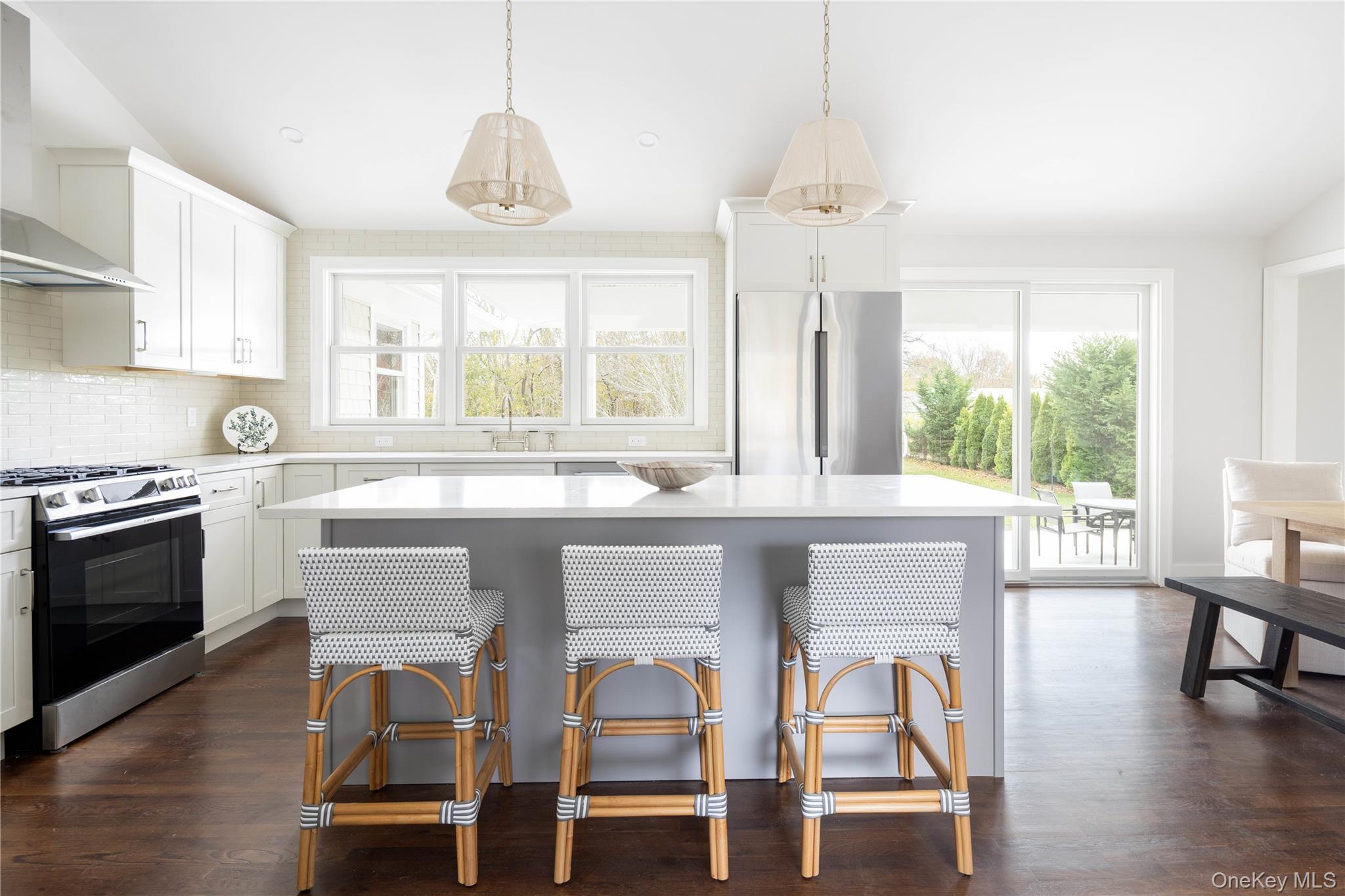 1995 Ruth Road Mattituck, NY 11952 - Photo 6 of 32 a kitchen with a dining table chairs and large windows