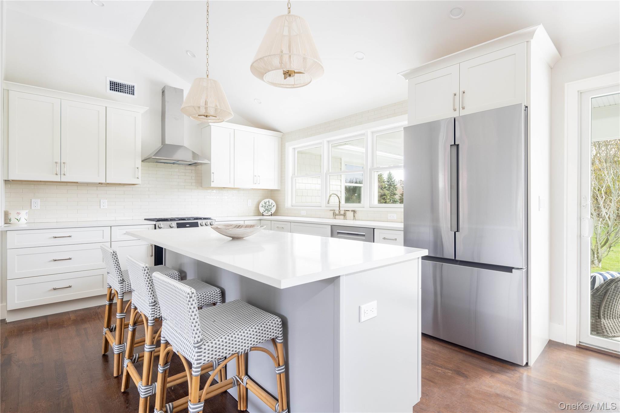 1995 Ruth Road Mattituck, NY 11952 - Photo 8 of 32 a kitchen with a refrigerator a stove a sink and white cabinets with wooden floor