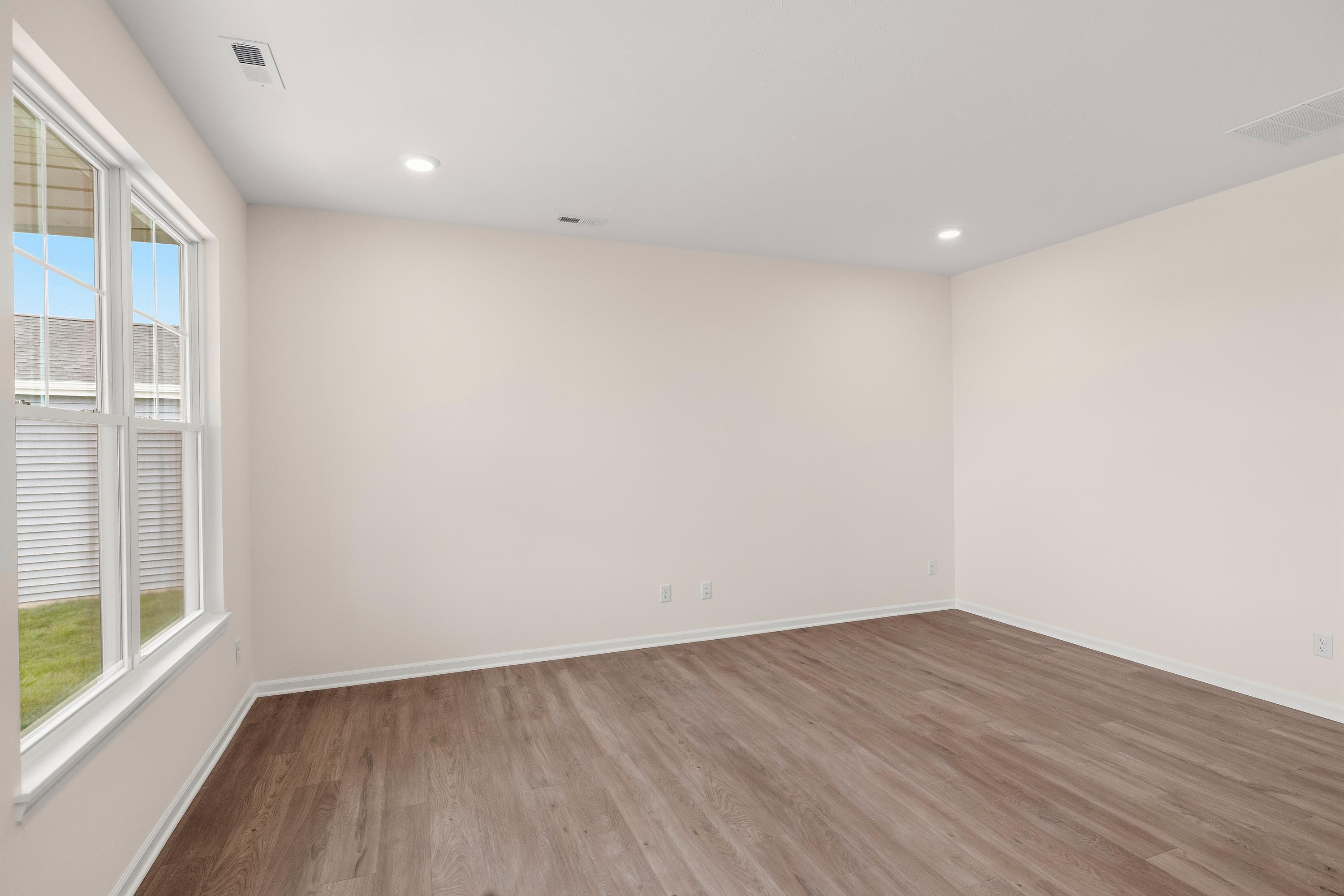 4053 Reflection Place Valparaiso, IN 46385 - Photo 11 of 18 a view of an empty room with wooden floor and a window