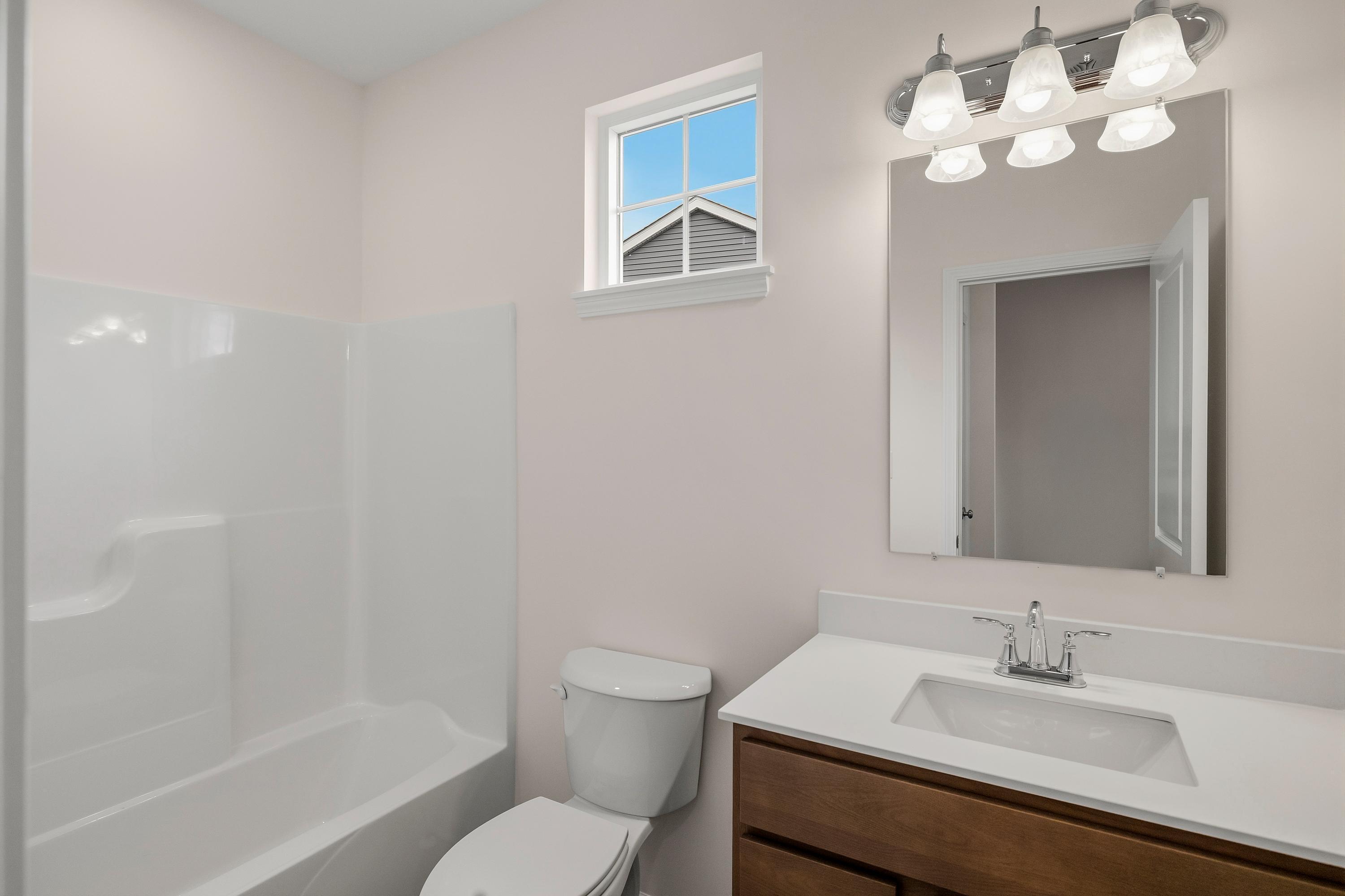 4053 Reflection Place Valparaiso, IN 46385 - Photo 5 of 18 a bathroom with a sink vanity mirror and toilet