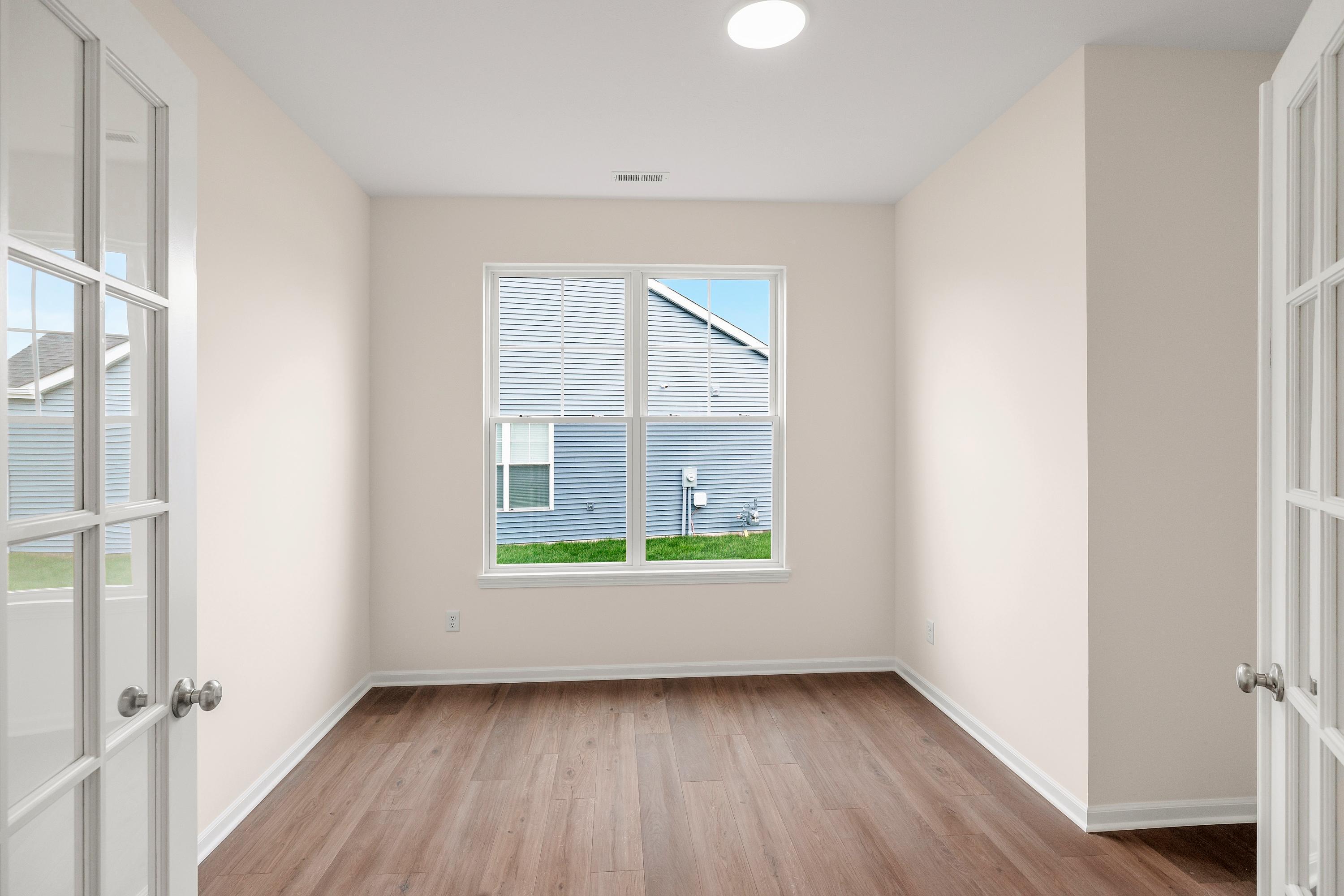 4053 Reflection Place Valparaiso, IN 46385 - Photo 6 of 18 an empty room with wooden floor and windows