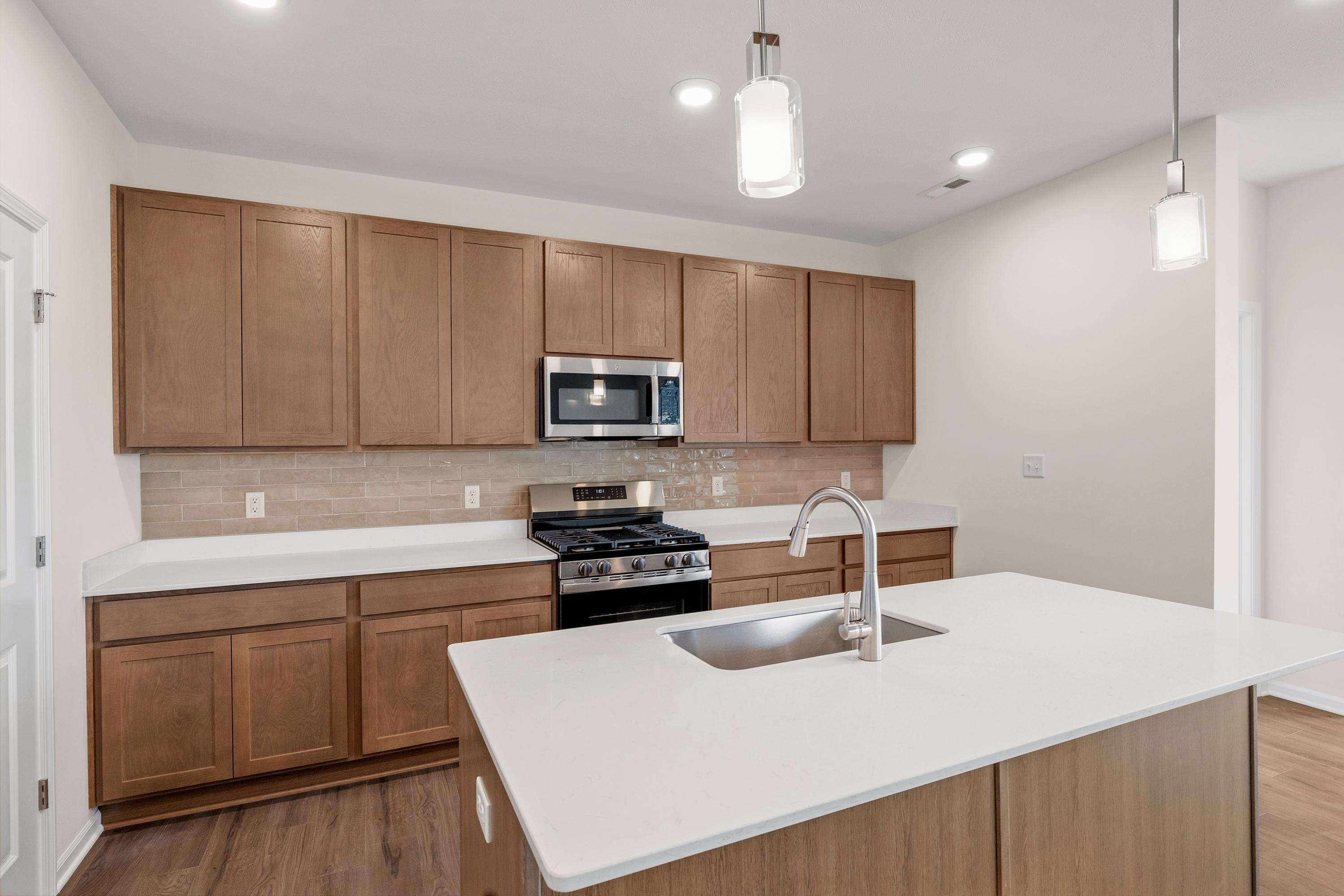 4053 Reflection Place Valparaiso, IN 46385 - Photo 8 of 18 a kitchen with a sink a stove and cabinets