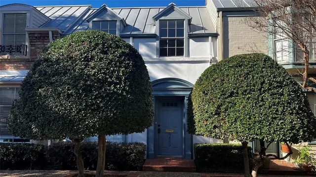front view of a house with a garden