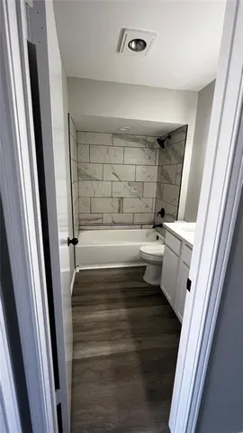 a view of a livingroom with a ceiling fan and window