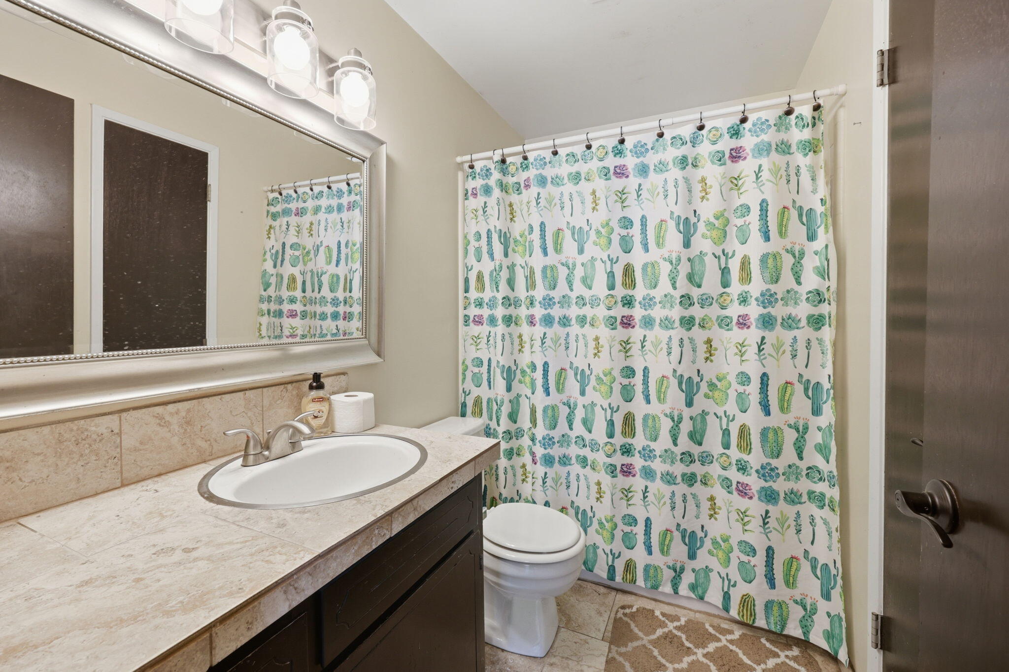 102 Elm Street Phoenix, OR 97535 - Photo 24 of 28 a bathroom with a granite countertop sink a toilet a mirror and shower curtain
