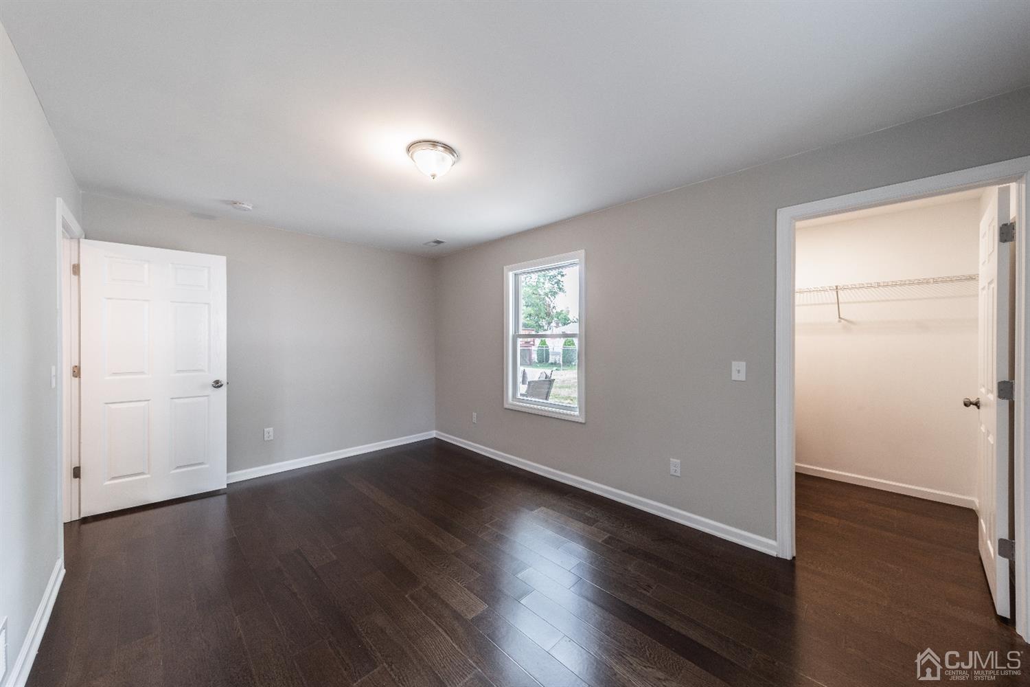 15 Dayton Road Edison, NJ 08817 - Photo 12 of 28 an empty room with wooden floor and windows
