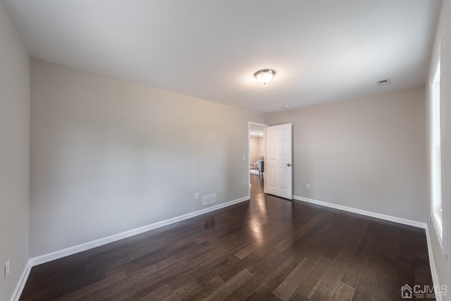 15 Dayton Road Edison, NJ 08817 - Photo 20 of 28 a view of an empty room with wooden floor