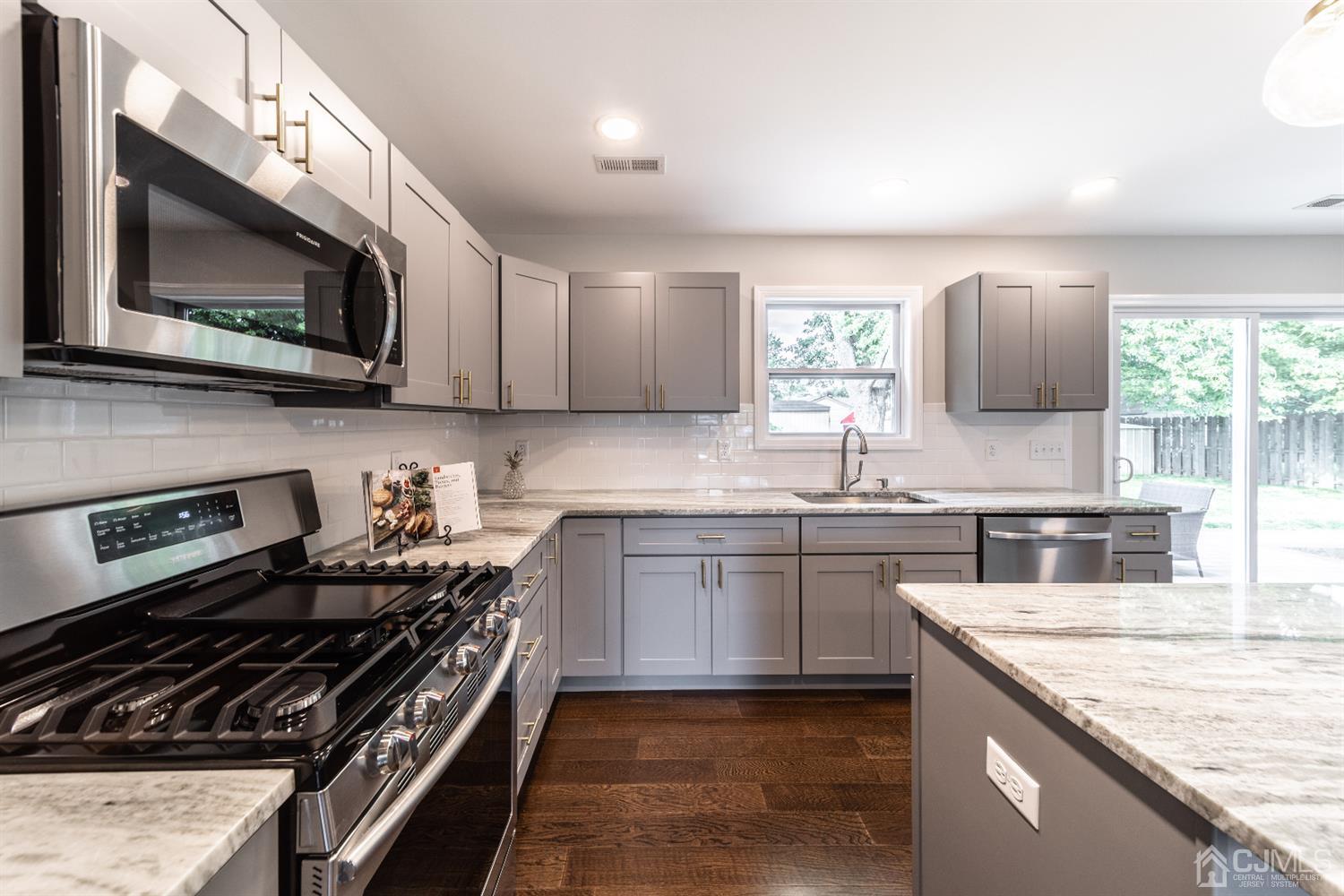 15 Dayton Road Edison, NJ 08817 - Photo 9 of 28 a kitchen with stainless steel appliances granite countertop a sink stove and microwave