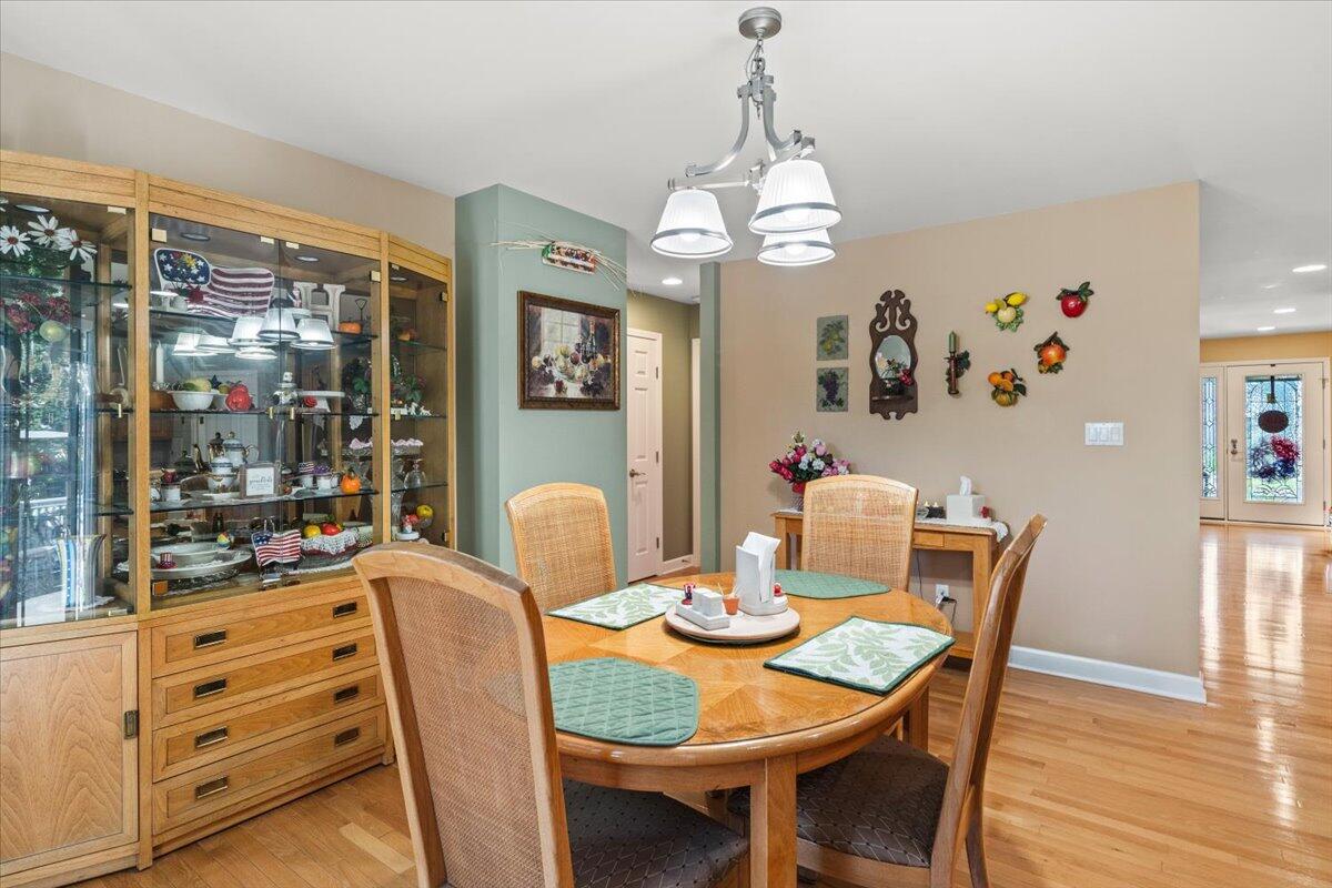 1270 East Greenview Place Crown Point, IN 46307 - Photo 14 of 44 a view of a dining room with furniture wooden floor and chandelier