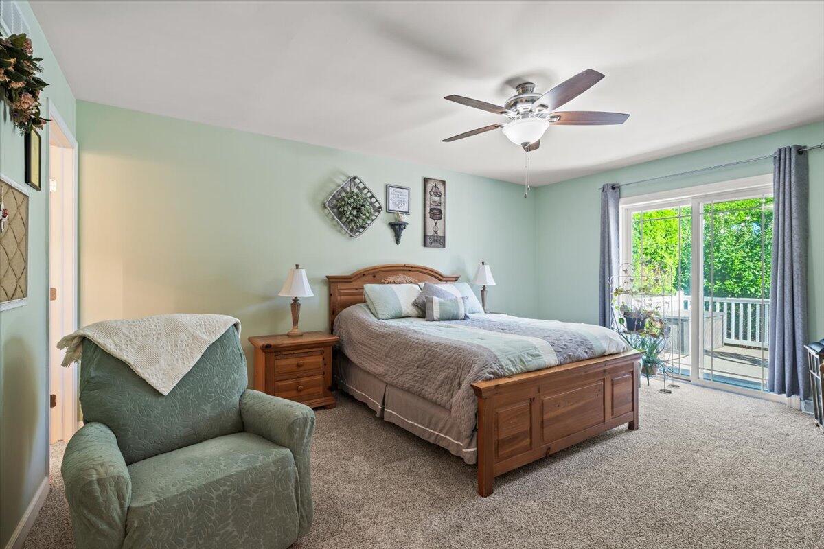 1270 East Greenview Place Crown Point, IN 46307 - Photo 15 of 44 a spacious bedroom with a bed and a couch