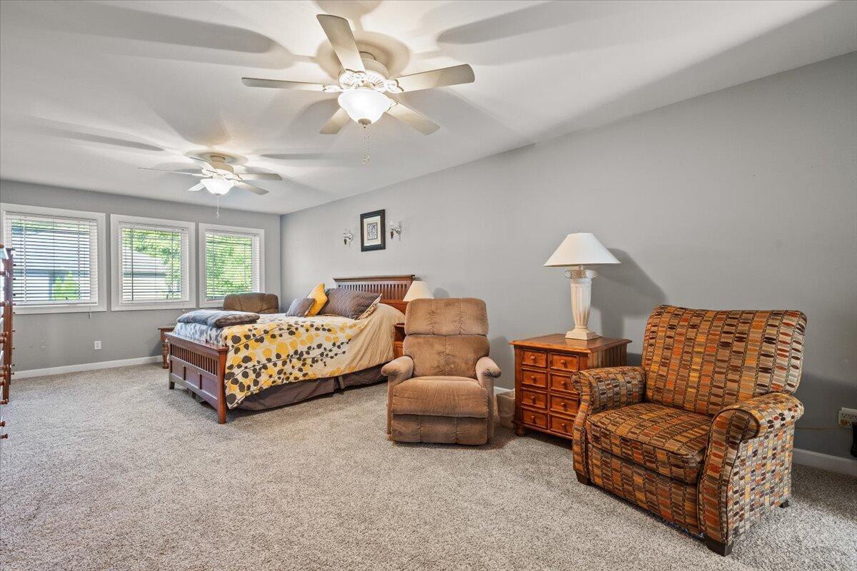 1270 East Greenview Place Crown Point, IN 46307 - Photo 26 of 44 a bedroom with a bed a couch and a chandelier