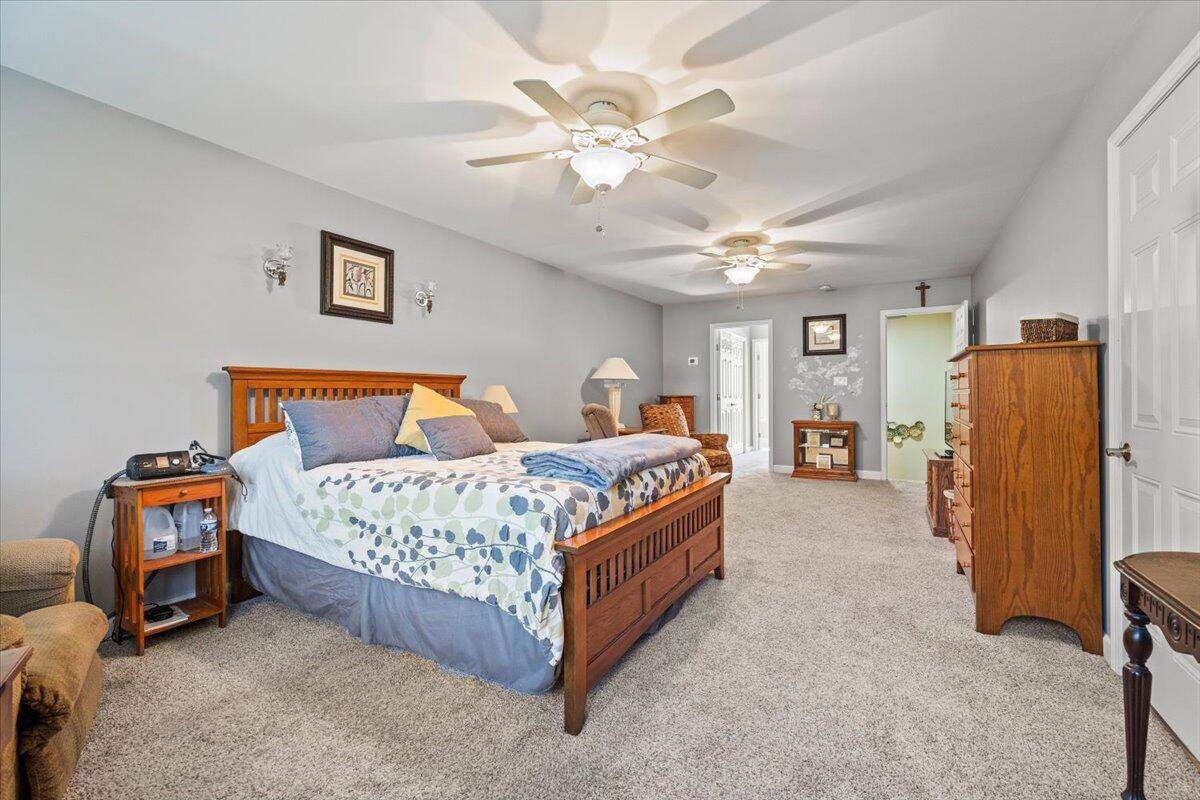 1270 East Greenview Place Crown Point, IN 46307 - Photo 27 of 44 a bedroom with bed and a chandelier