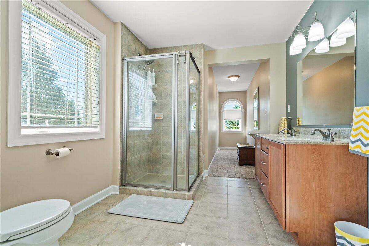 1270 East Greenview Place Crown Point, IN 46307 - Photo 28 of 44 a bathroom with a double vanity sink toilet and shower