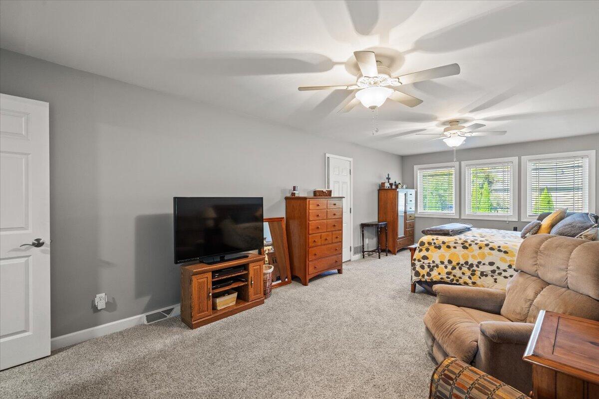 1270 East Greenview Place Crown Point, IN 46307 - Photo 30 of 44 a living room with furniture and a flat screen tv