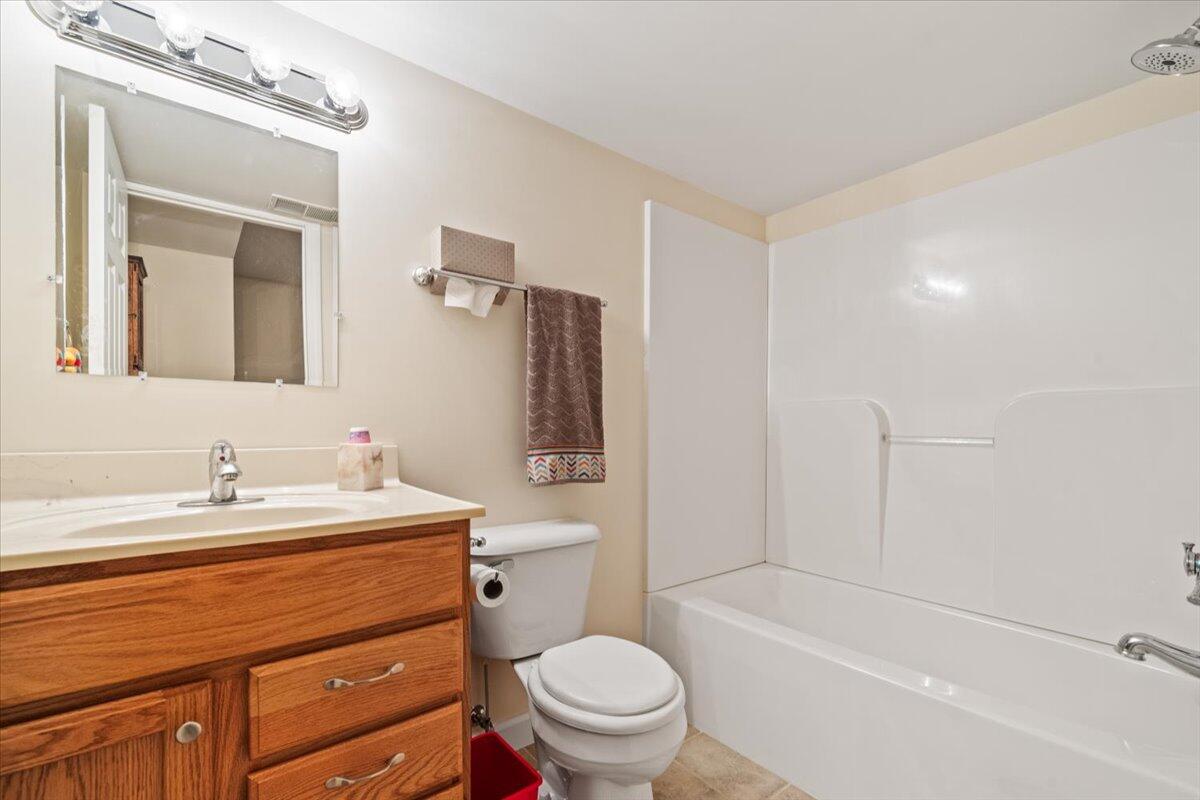 1270 East Greenview Place Crown Point, IN 46307 - Photo 36 of 44 a bathroom with a sink a toilet and a large mirror