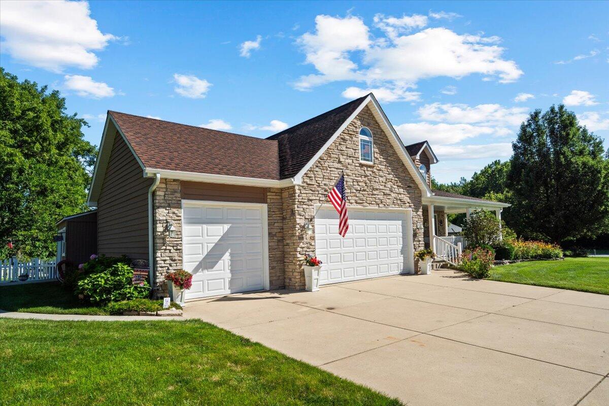 1270 East Greenview Place Crown Point, IN 46307 - Photo 40 of 44 a front view of a house with a yard and garage