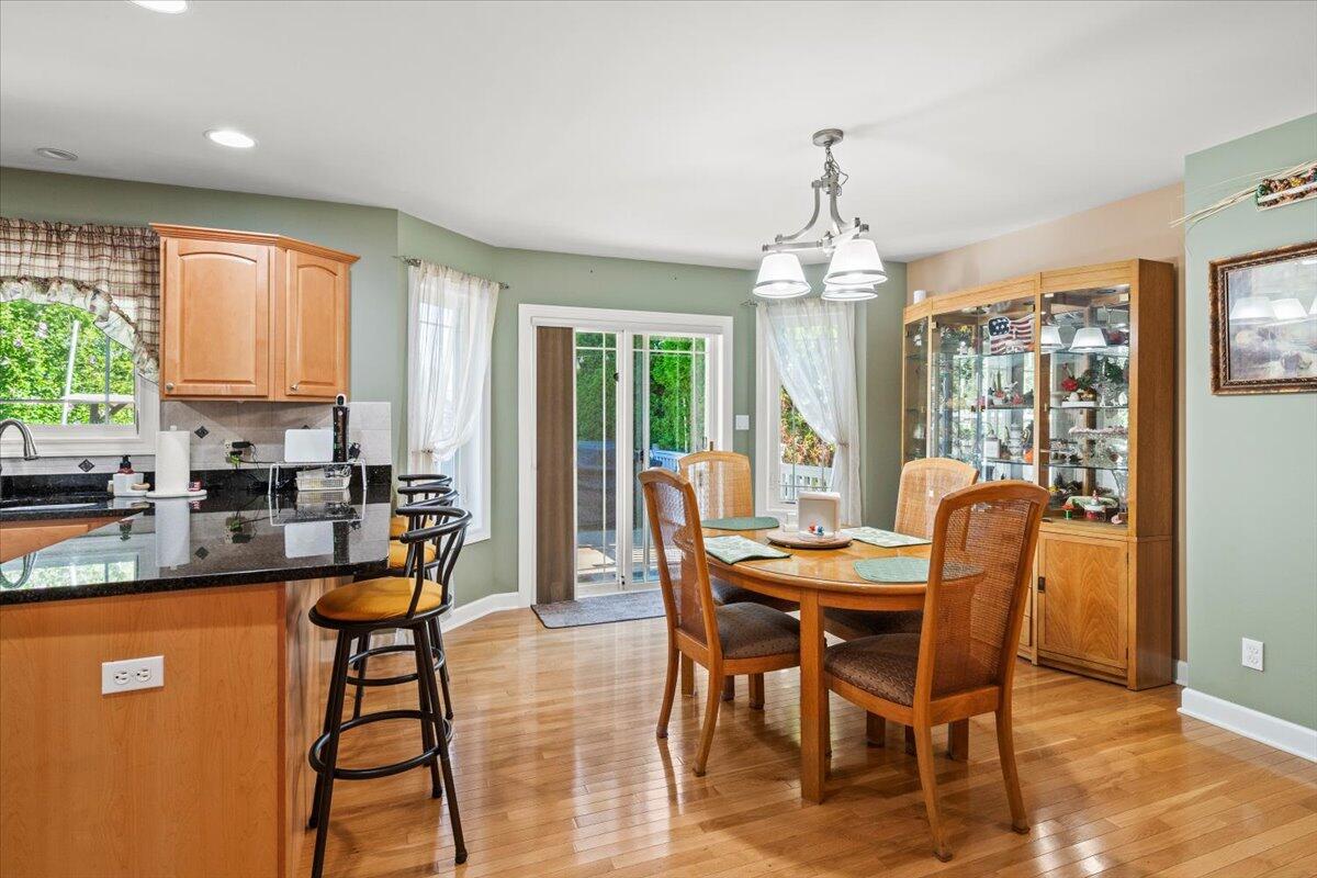 1270 East Greenview Place Crown Point, IN 46307 - Photo 9 of 44 a dining room with furniture window wooden floor