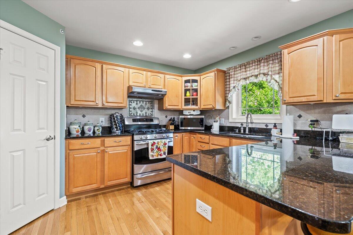 1270 East Greenview Place Crown Point, IN 46307 - Photo 10 of 44 a kitchen with stainless steel appliances granite countertop a stove a sink and a refrigerator