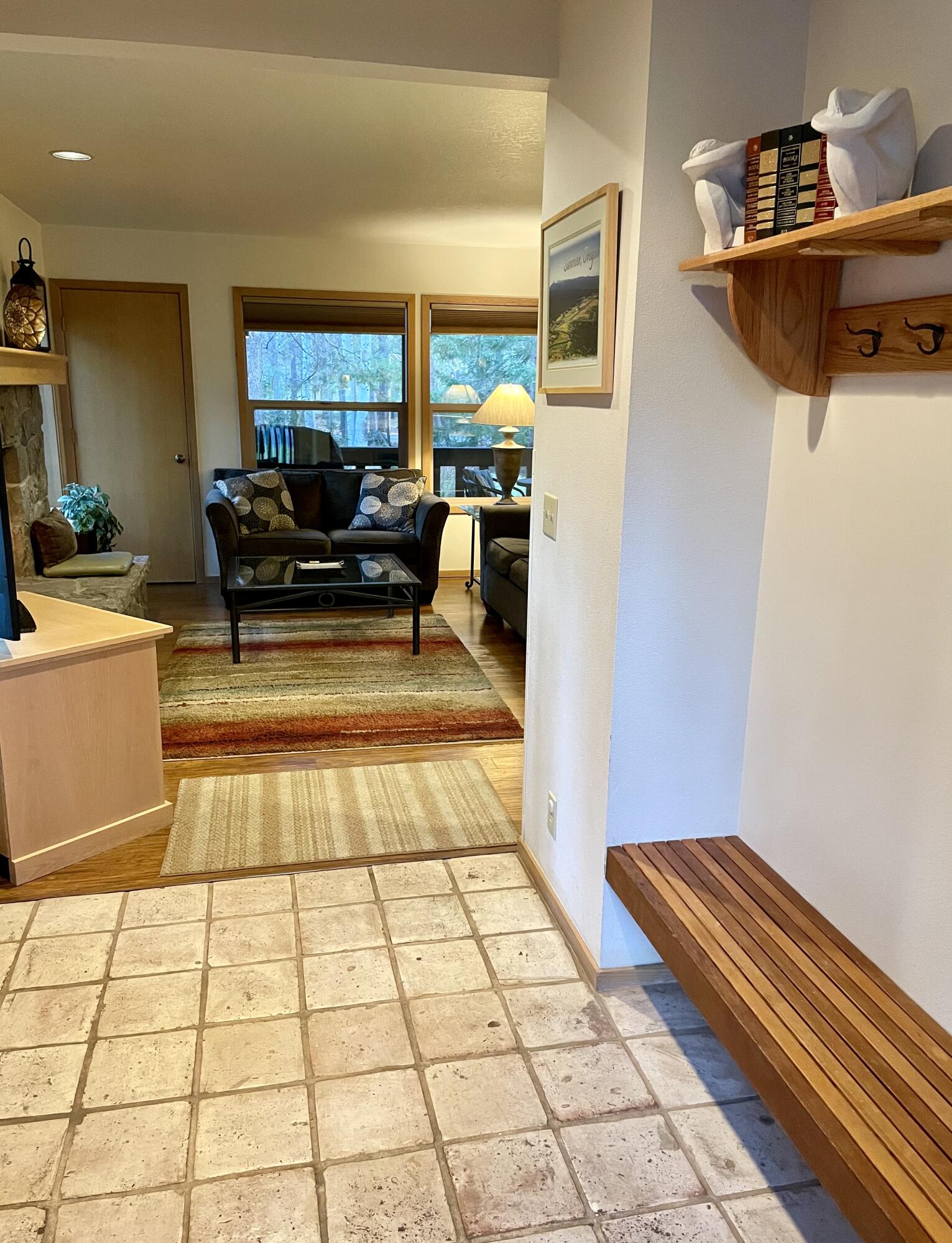 57376 Beaver Ridge Loop, Unit 33C1 Sunriver, OR 97707 - Photo 2 of 35 a living room with a black white checkered floor with a gaming machine and a table