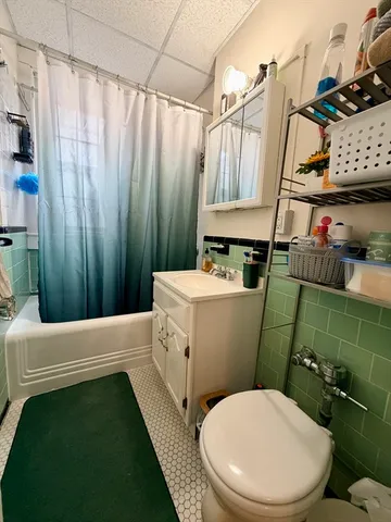 a bathroom with a sink a toilet and tub