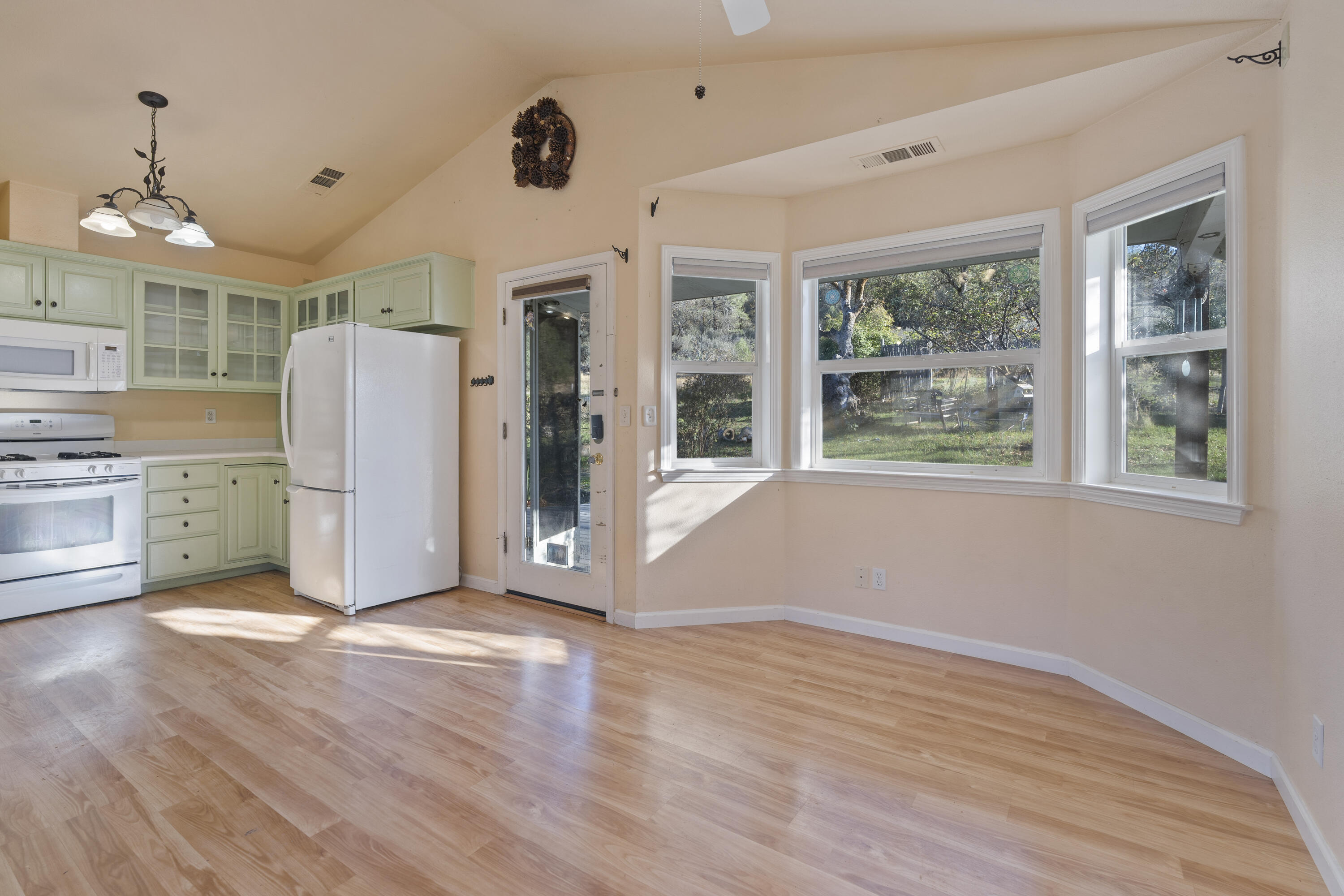 6841 Vista Lavega Road Shingletown, CA 96088 - Photo 13 of 80 a view of an empty room with a window and wooden floor