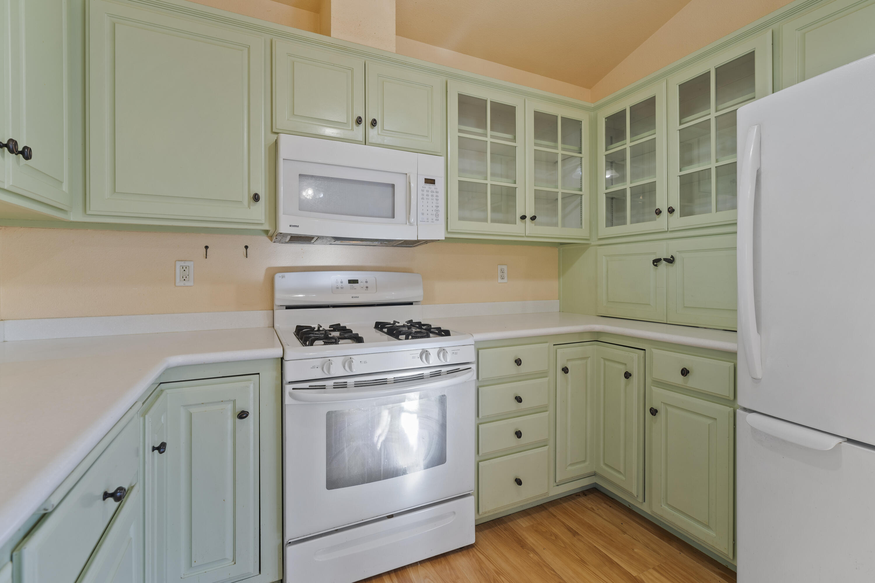 6841 Vista Lavega Road Shingletown, CA 96088 - Photo 14 of 80 a kitchen with granite countertop white cabinets and a stove with wooden floor
