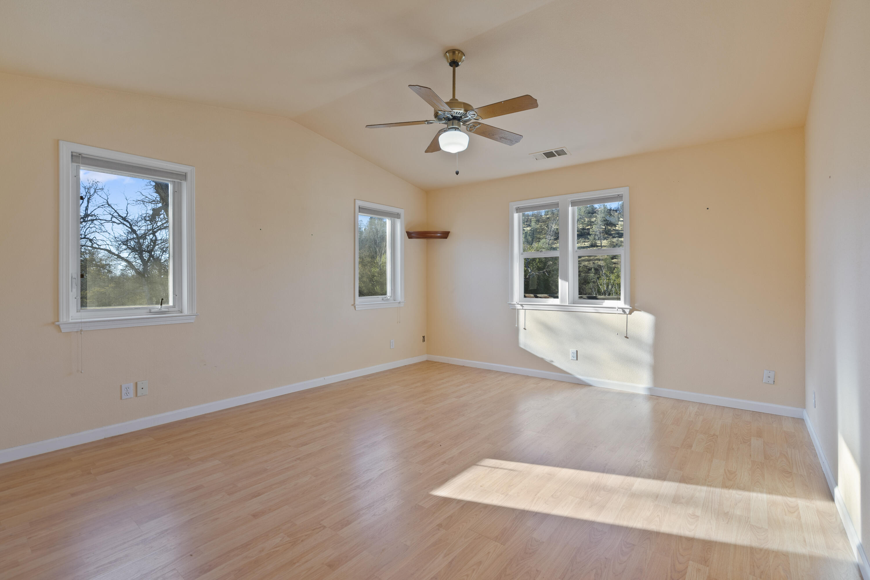 6841 Vista Lavega Road Shingletown, CA 96088 - Photo 16 of 57 a view of an empty room with a window and wooden floor
