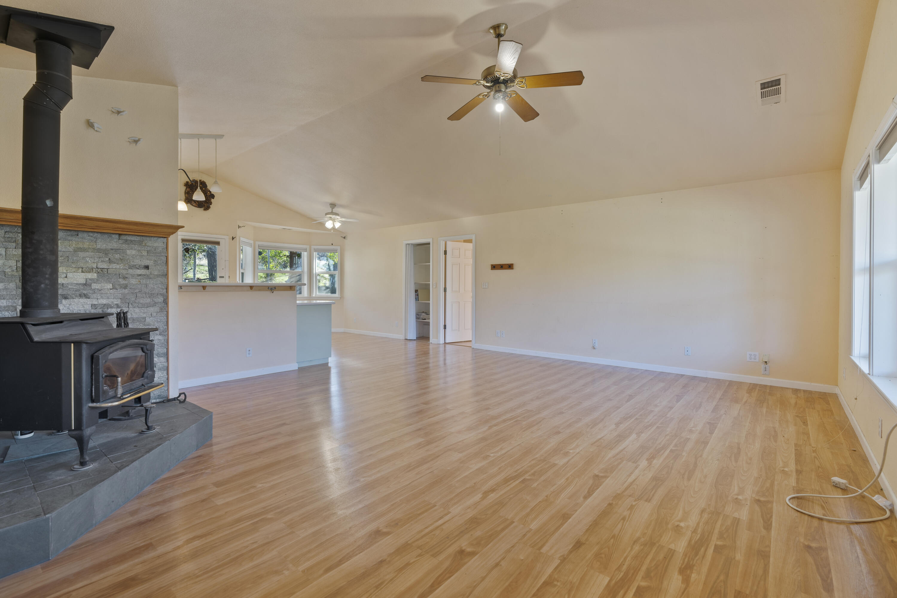 6841 Vista Lavega Road Shingletown, CA 96088 - Photo 17 of 80 a view of empty room with wooden floor and fireplace