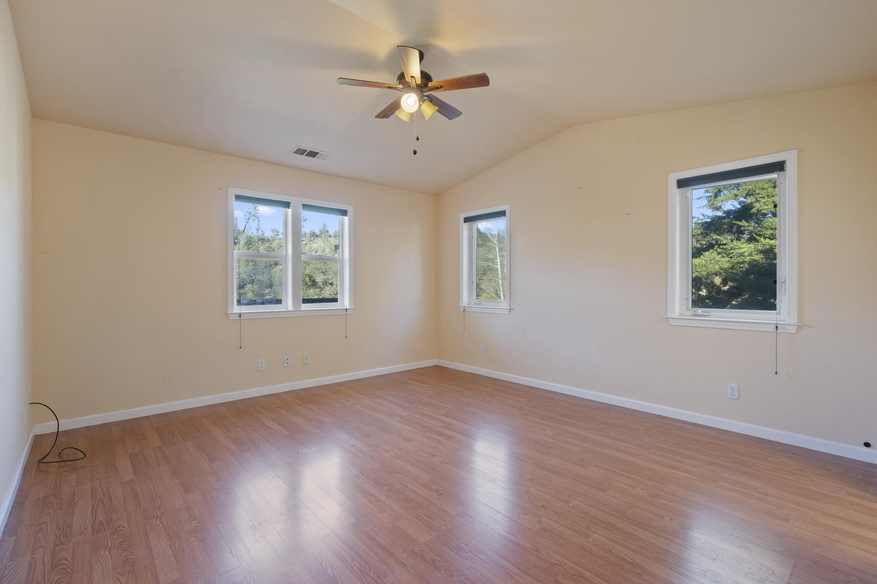 6841 Vista Lavega Road Shingletown, CA 96088 - Photo 21 of 57 a view of an empty room with wooden floor and a window