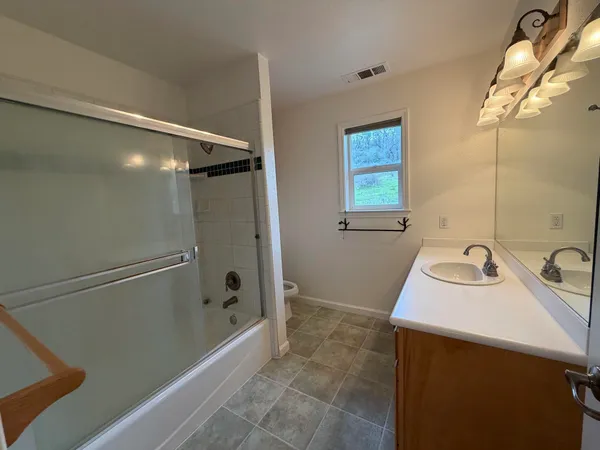 a view of a field with trees in the background