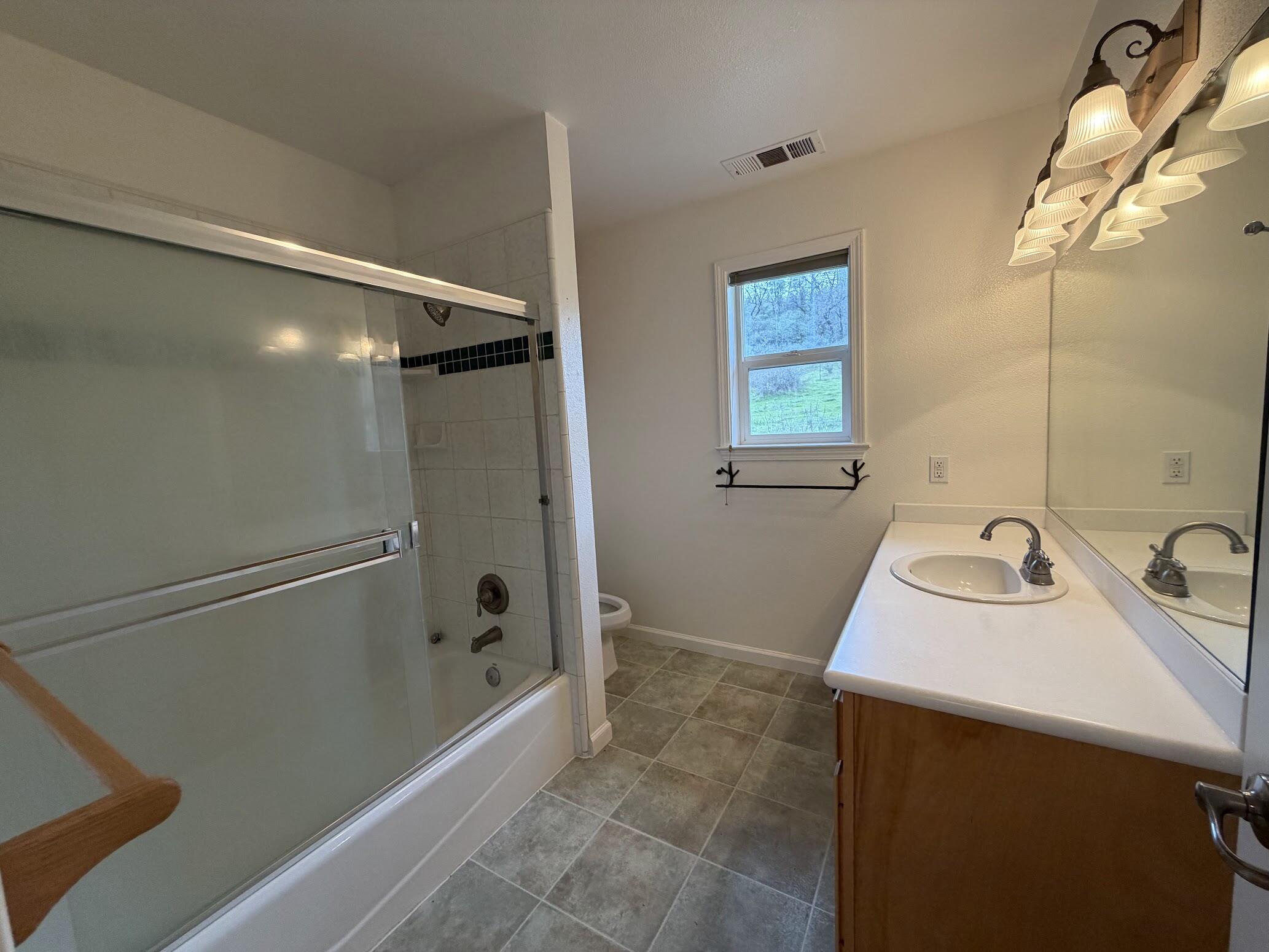 6841 Vista Lavega Road Shingletown, CA 96088 - Photo 24 of 80 a bathroom with a sink a mirror and a bathtub