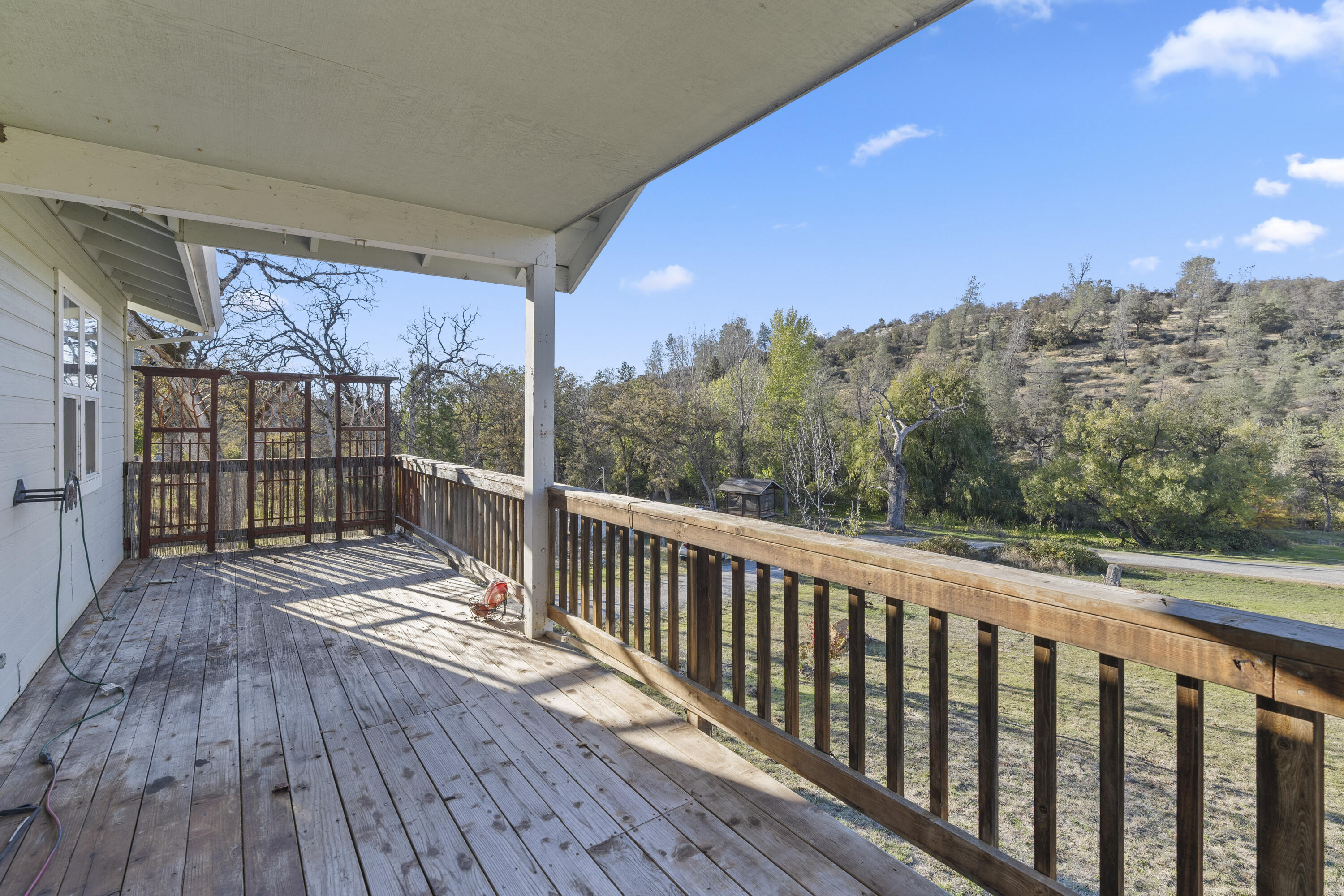 6841 Vista Lavega Road Shingletown, CA 96088 - Photo 32 of 80 a view of balcony with wooden floor and fence