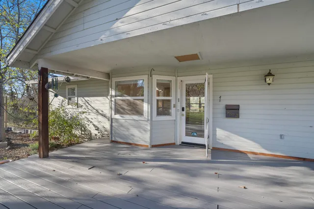 a view of kitchen with stainless steel appliances granite countertop cabinets and wooden floor