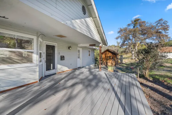 a view of a livingroom with a fireplace a chandelier a wooden table and chairs