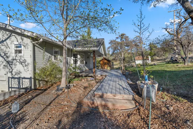 a kitchen with granite countertop white cabinets and a stove with wooden floor