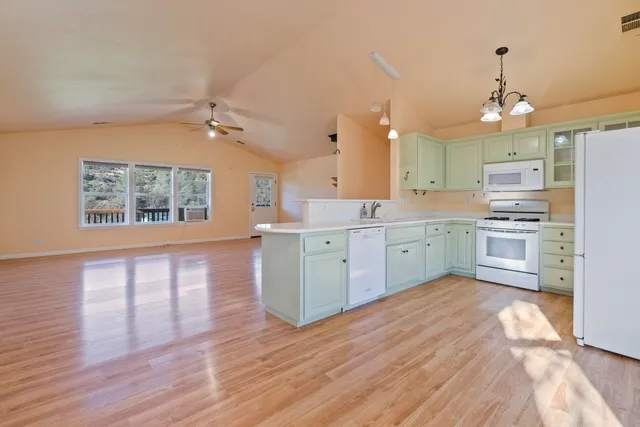 a view of empty room with wooden floor and fireplace