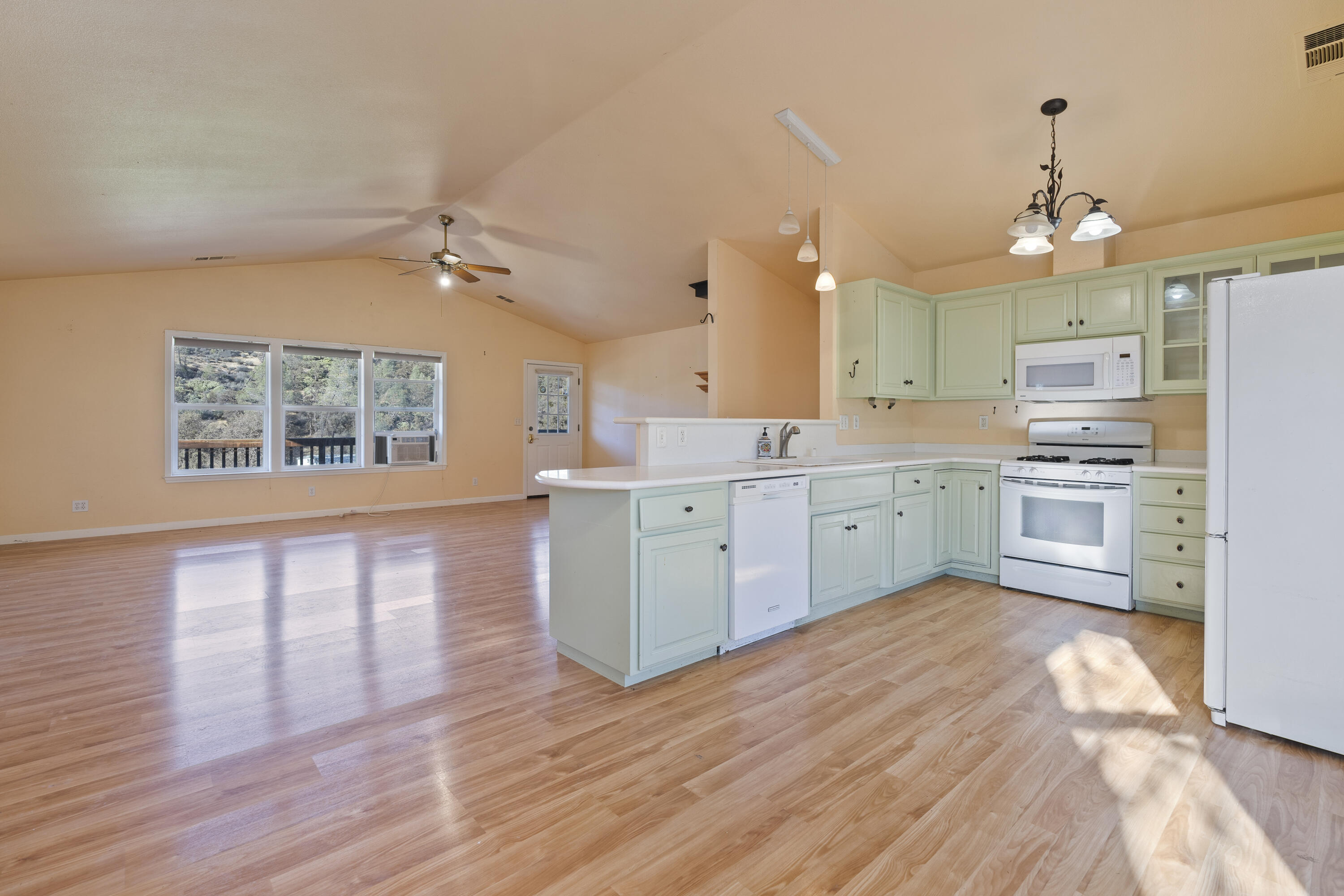 6841 Vista Lavega Road Shingletown, CA 96088 - Photo 9 of 80 a large kitchen with cabinets wooden floor and stainless steel appliances